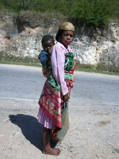 A woman carrying her child